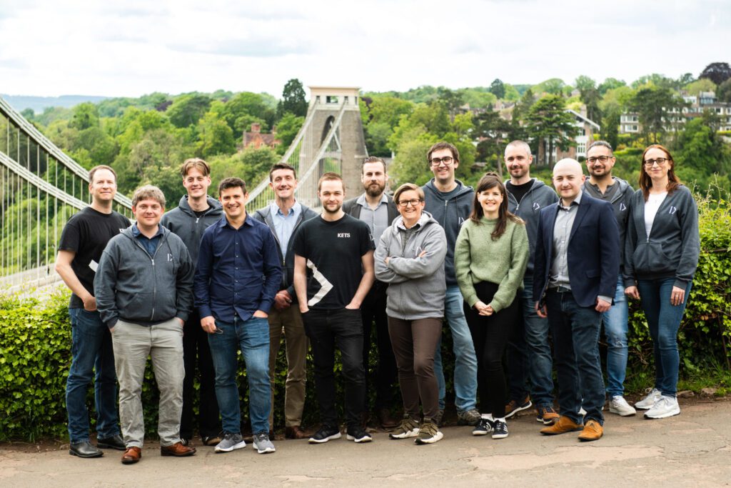 A group of 14 people stood in front of Clifton Suspension Bridge, Bristol.