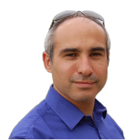 A headshot of Adam Sandman.