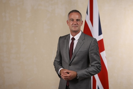 Peter Kyle, Secretary of State for Science, Innovation and Technology, standing in front of a Union flag.