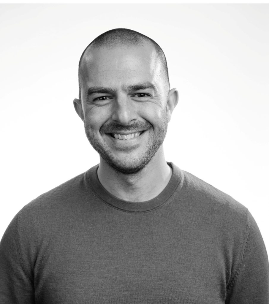 A black and white headshot of Oscar De Mello, head of operations and business at The Sheds.