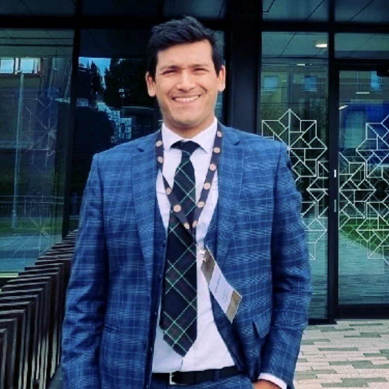 A headshot of Azmat Hossain.