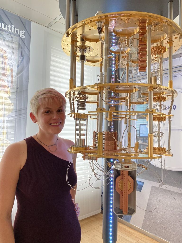Katia Moskvitch stands next to quantum machinery.