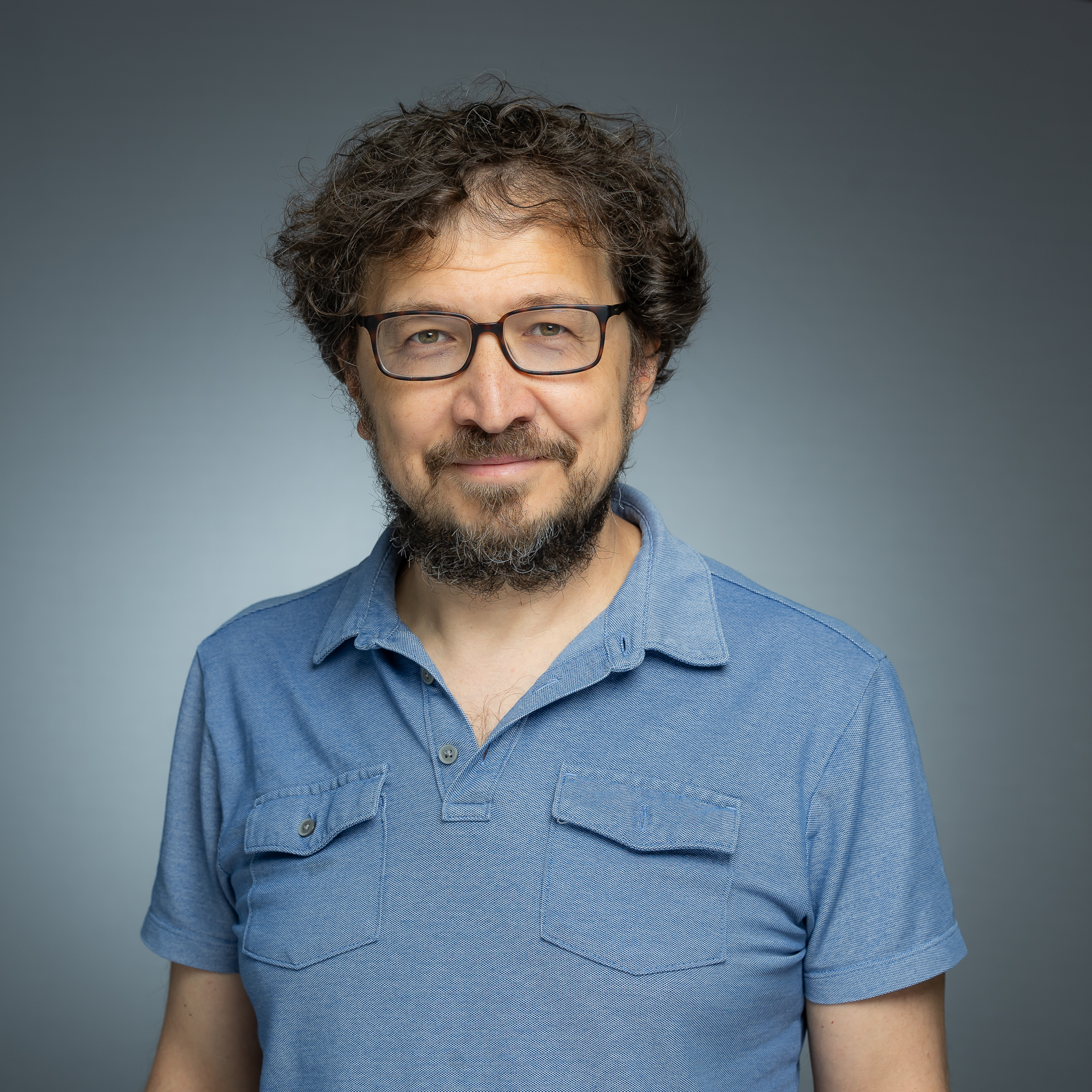 A headshot of Emre Ozer.